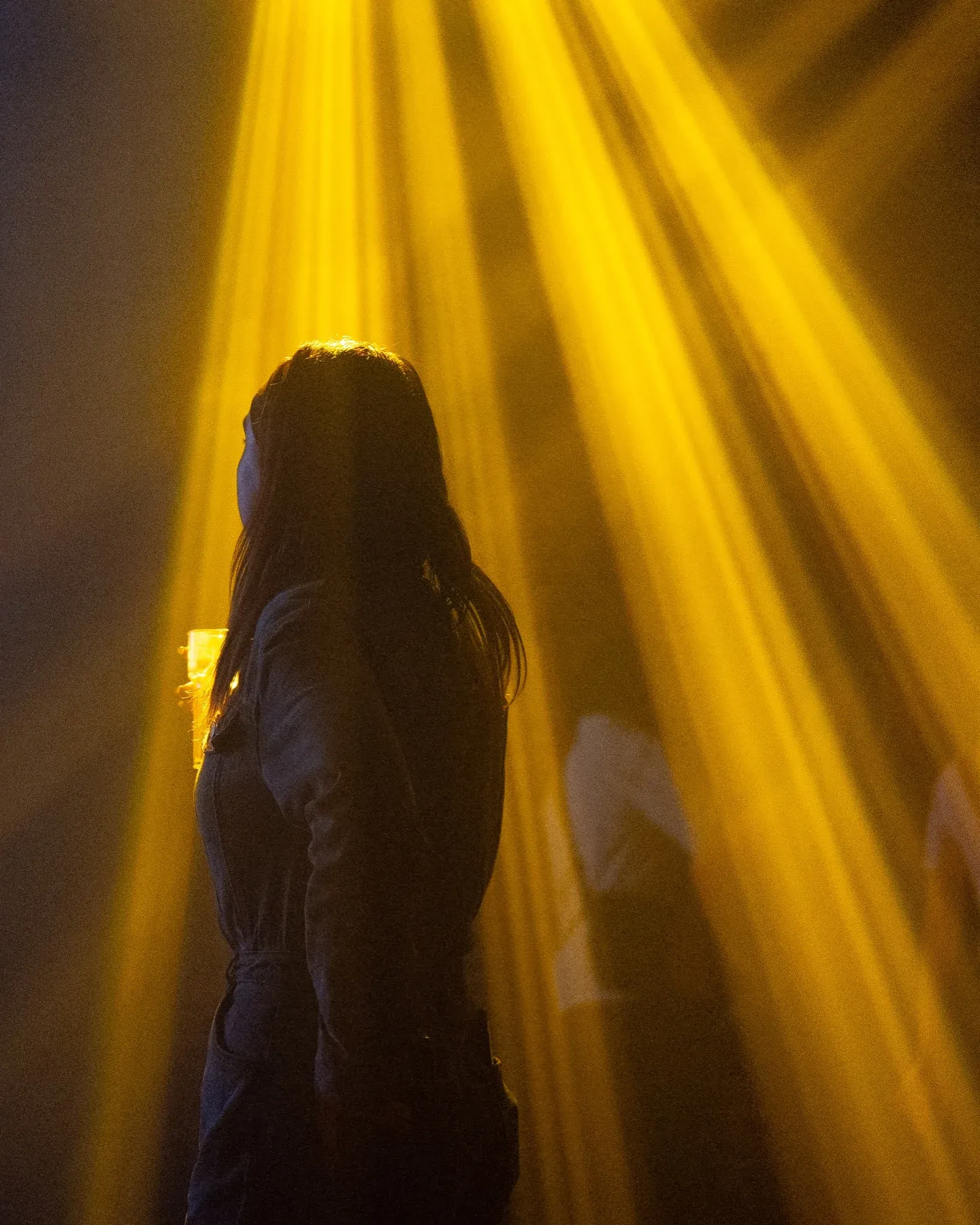 Yellow light beams over the dance floor