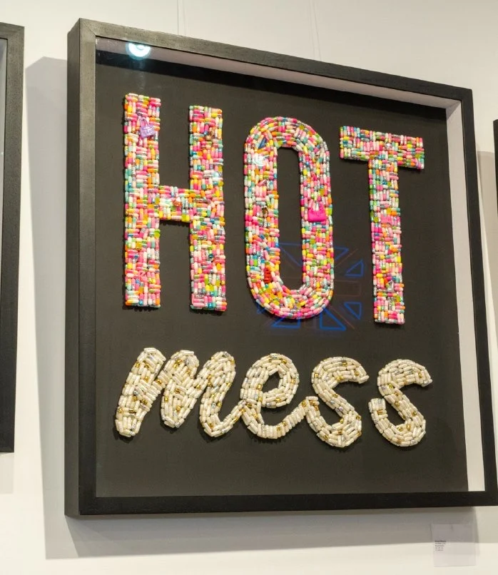 Framed Hot Mess beaded artwork on a gallery wall