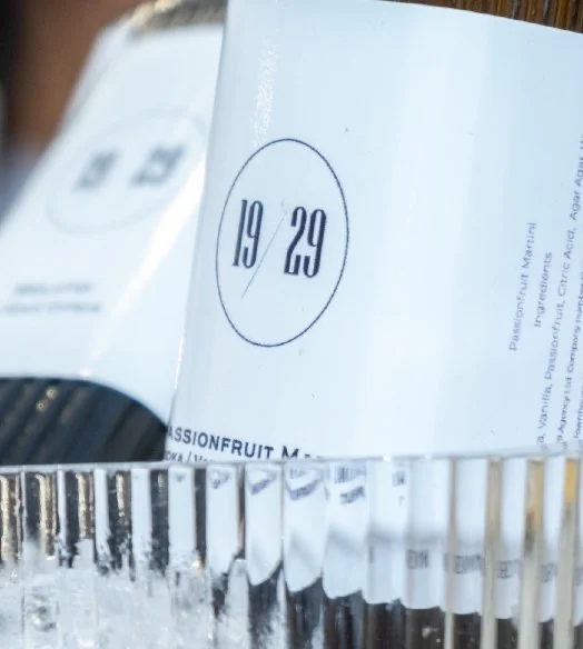 19/29 bottle labels above a row of glasses