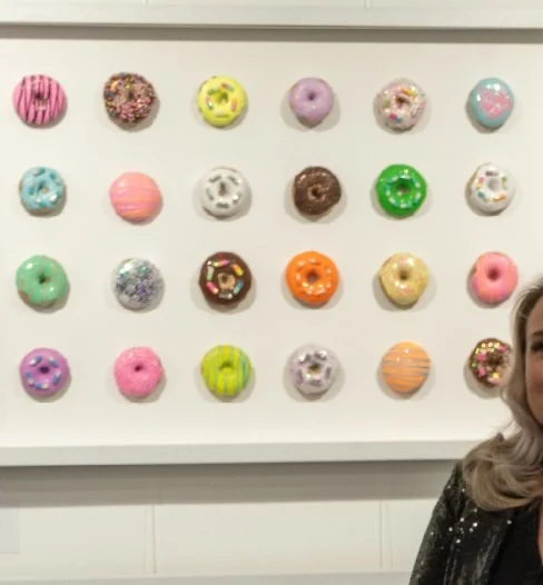 Wall of doughnut artworks at the gallery