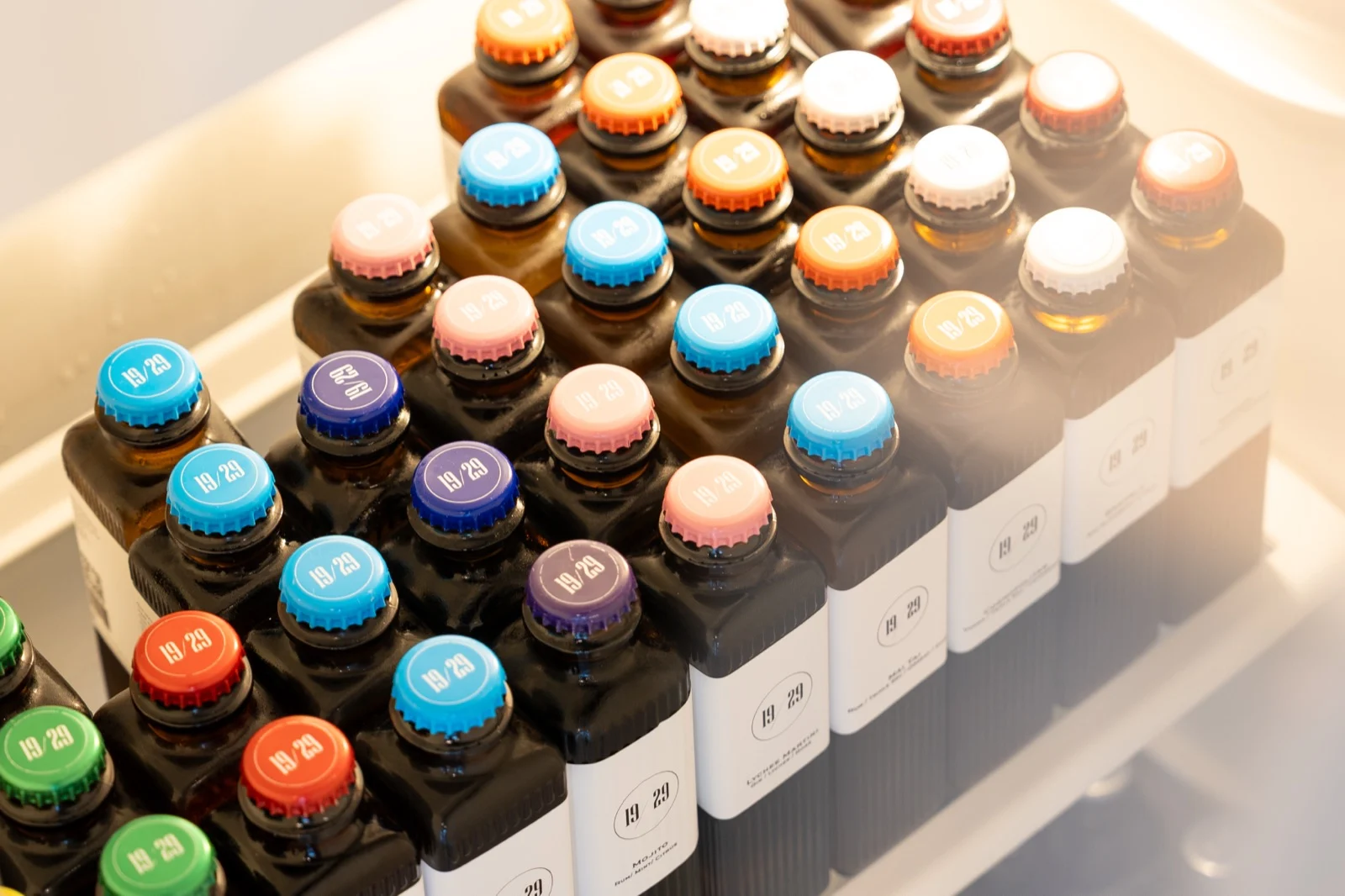 Rows of 19/29 bottles with coloured caps