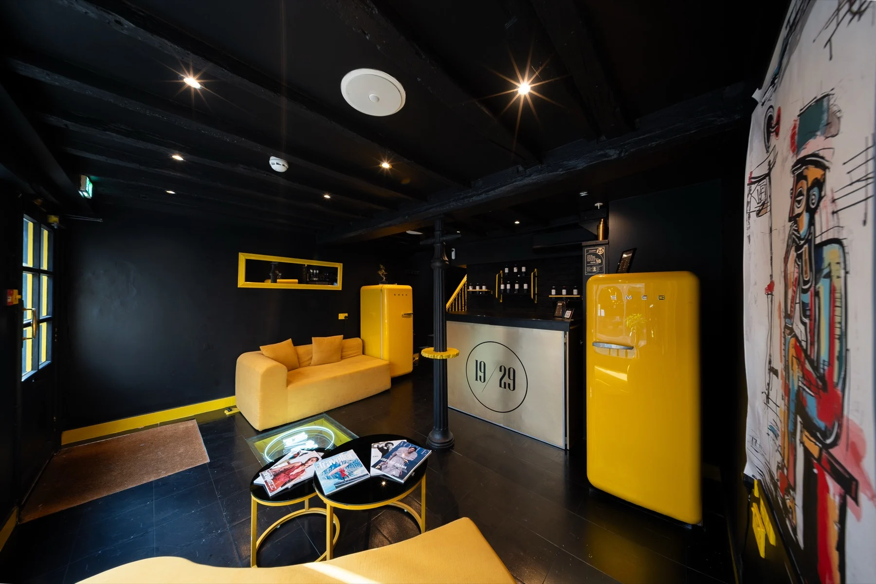 Inside the 19/29 shop on Fore Street, Hertford: yellow sofa, yellow fridge and the 19/29 counter