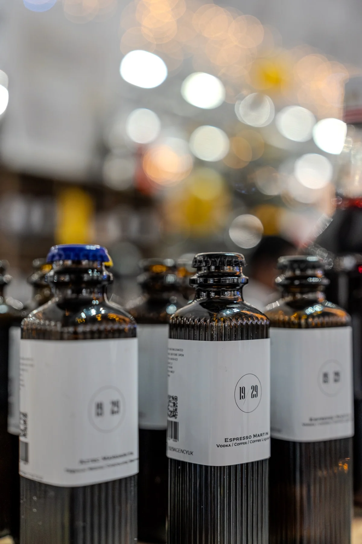 19/29 bottles with crown caps, Christmas lights behind