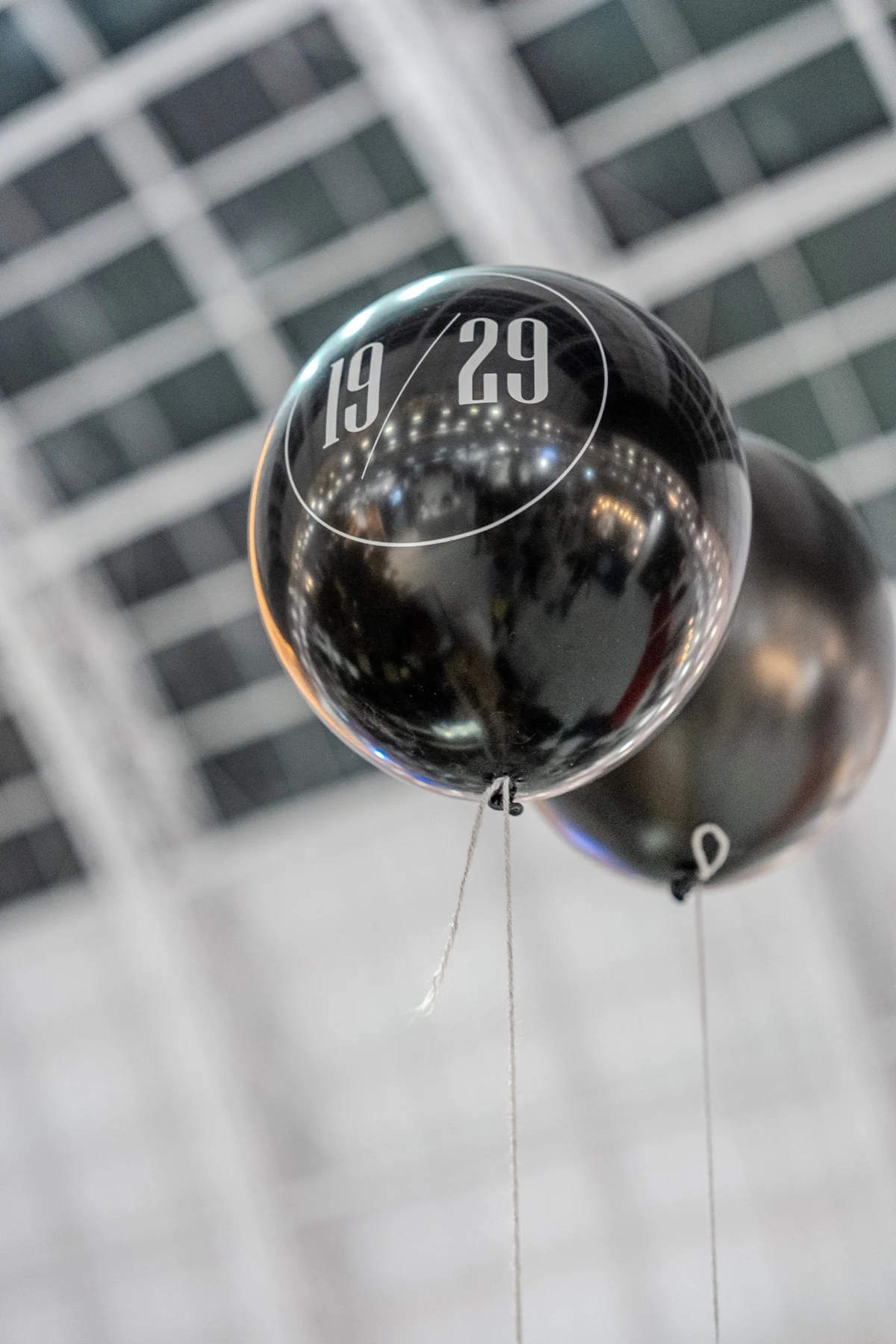 Black 19/29 balloons under the Olympia glass roof