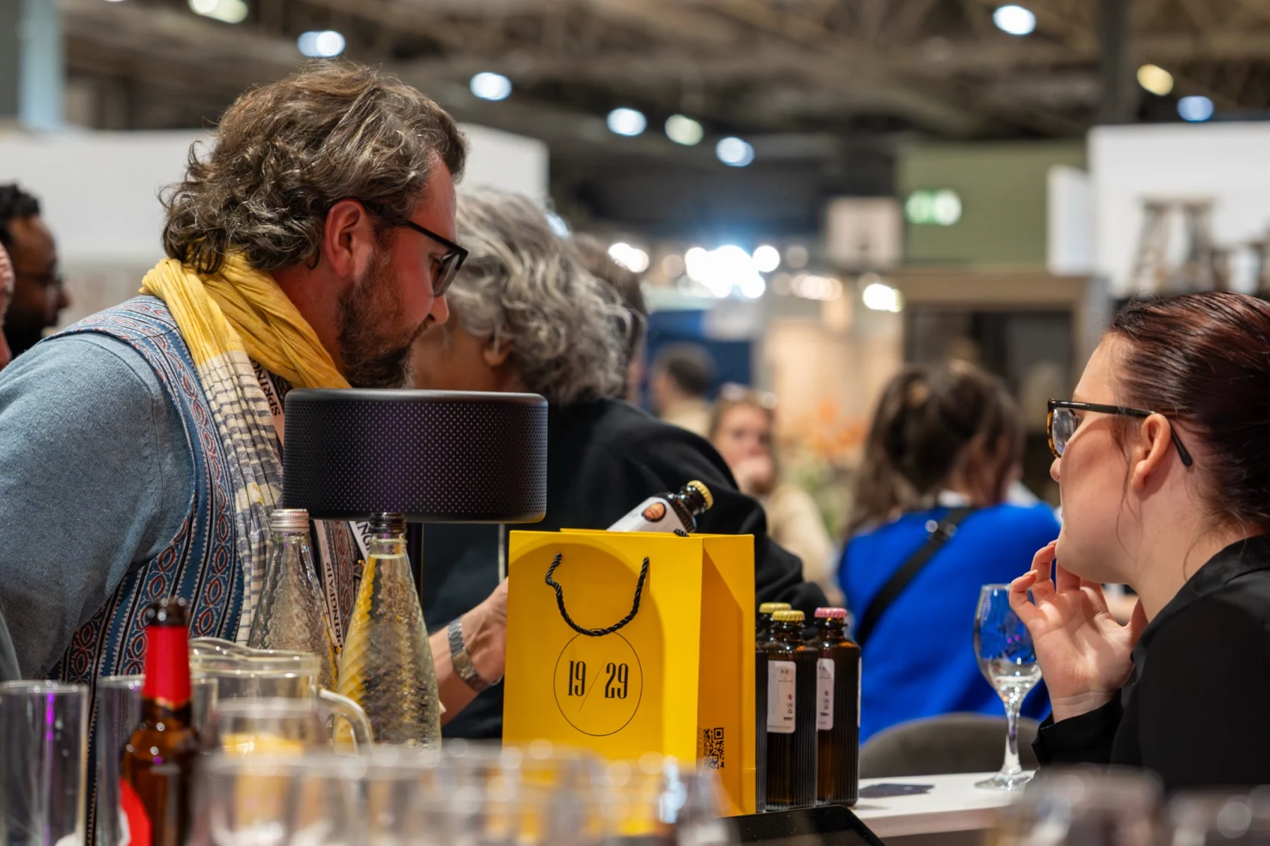 Guests at a table with a yellow 19/29 gift bag