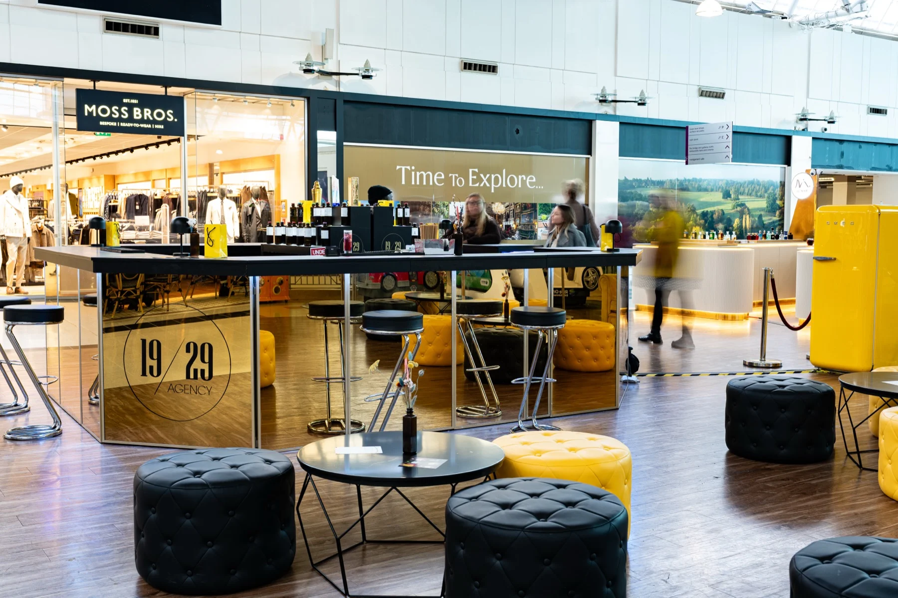 The 19/29 pop-up lounge with black and yellow pouffes
