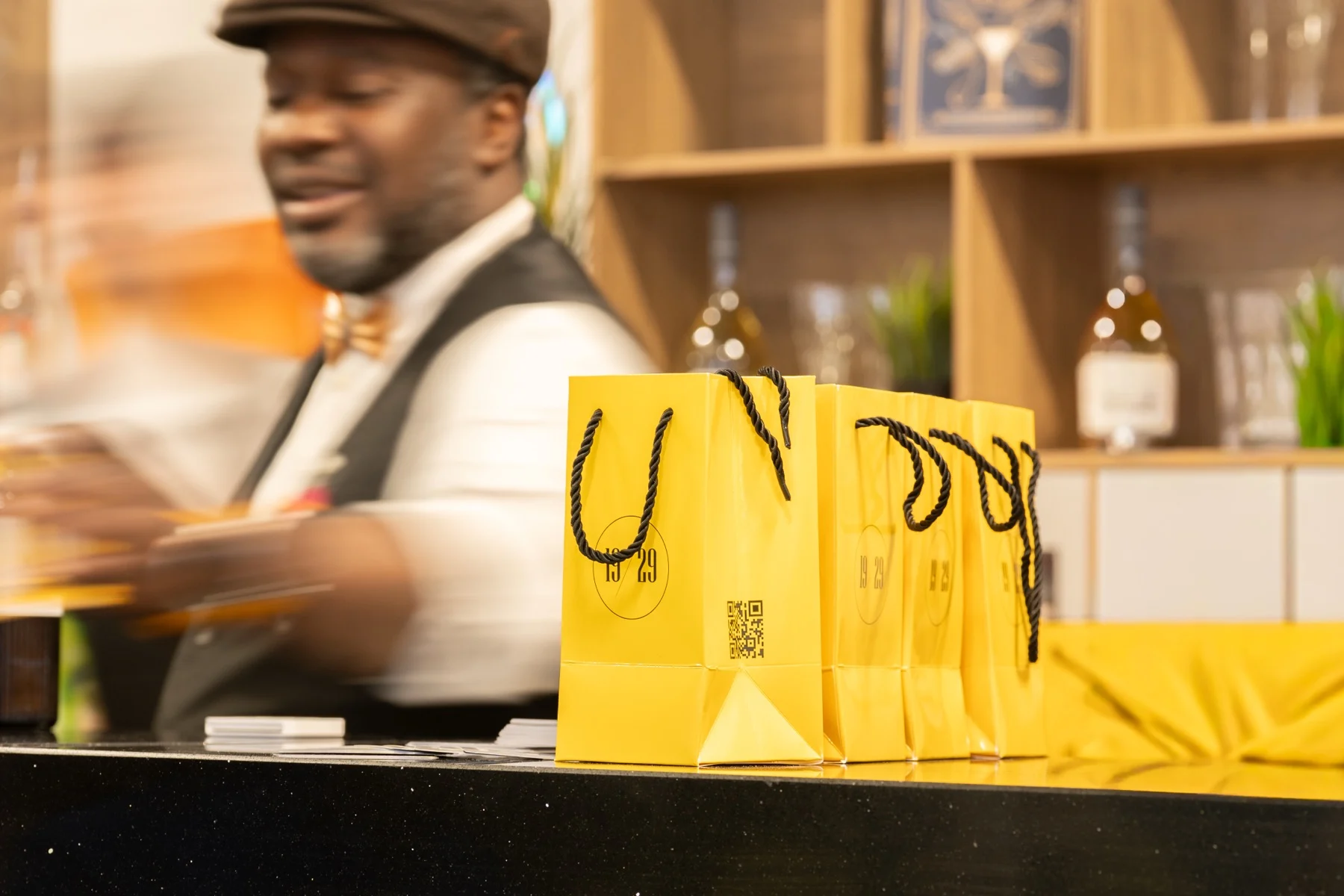 The 19/29 stand with yellow gift bags